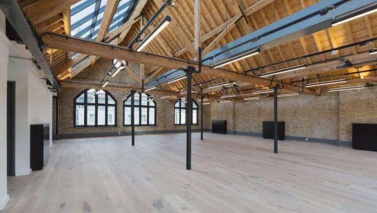warehouse office space with exposed roof beams and rafters