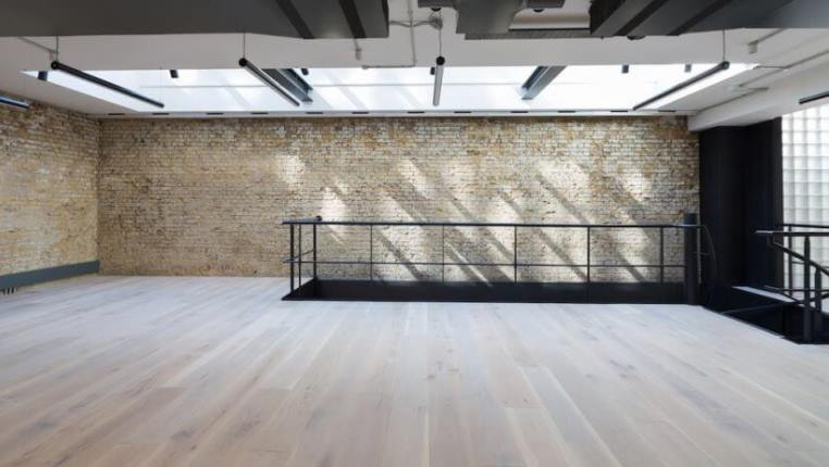 large office suite with exposed brickwork and glass block wall